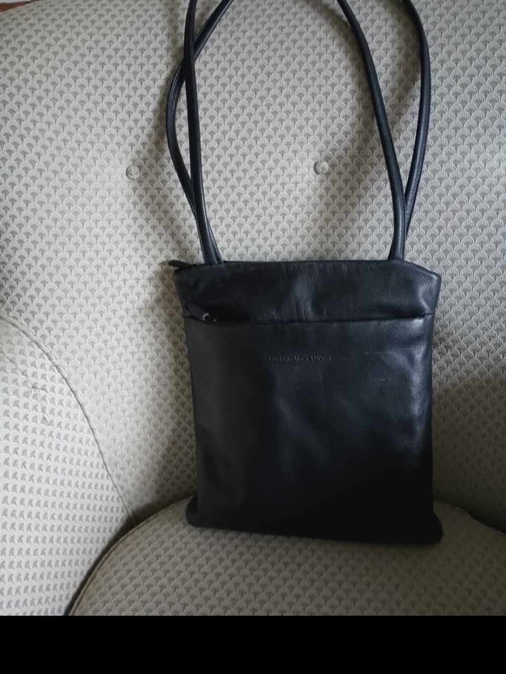 black soft leather bag by Derek Alexander features a signature sewn-in leat